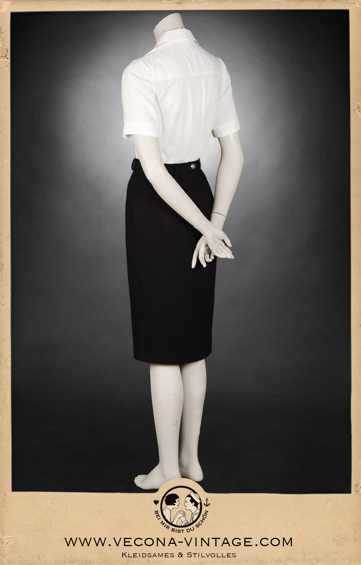 Back view of 1940s high waist pencil skirt Apache in black paired with the short sleeve blouse Greta in cream white.