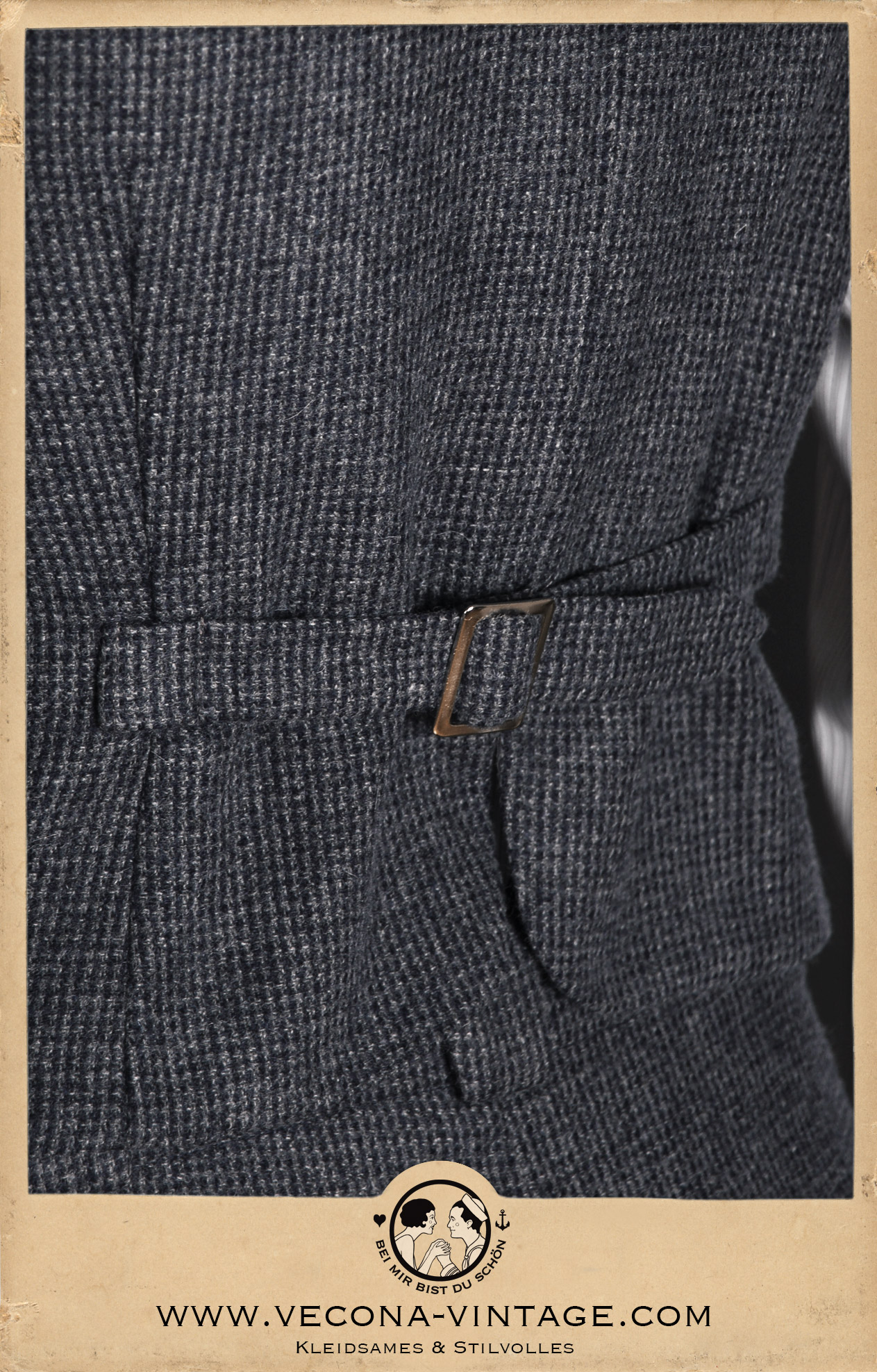 Close-up photo of the adjustable back strap at the HICKORY CHAMP waistcoat made from pure new wool tweed with blue and grey houndstooth pattern.