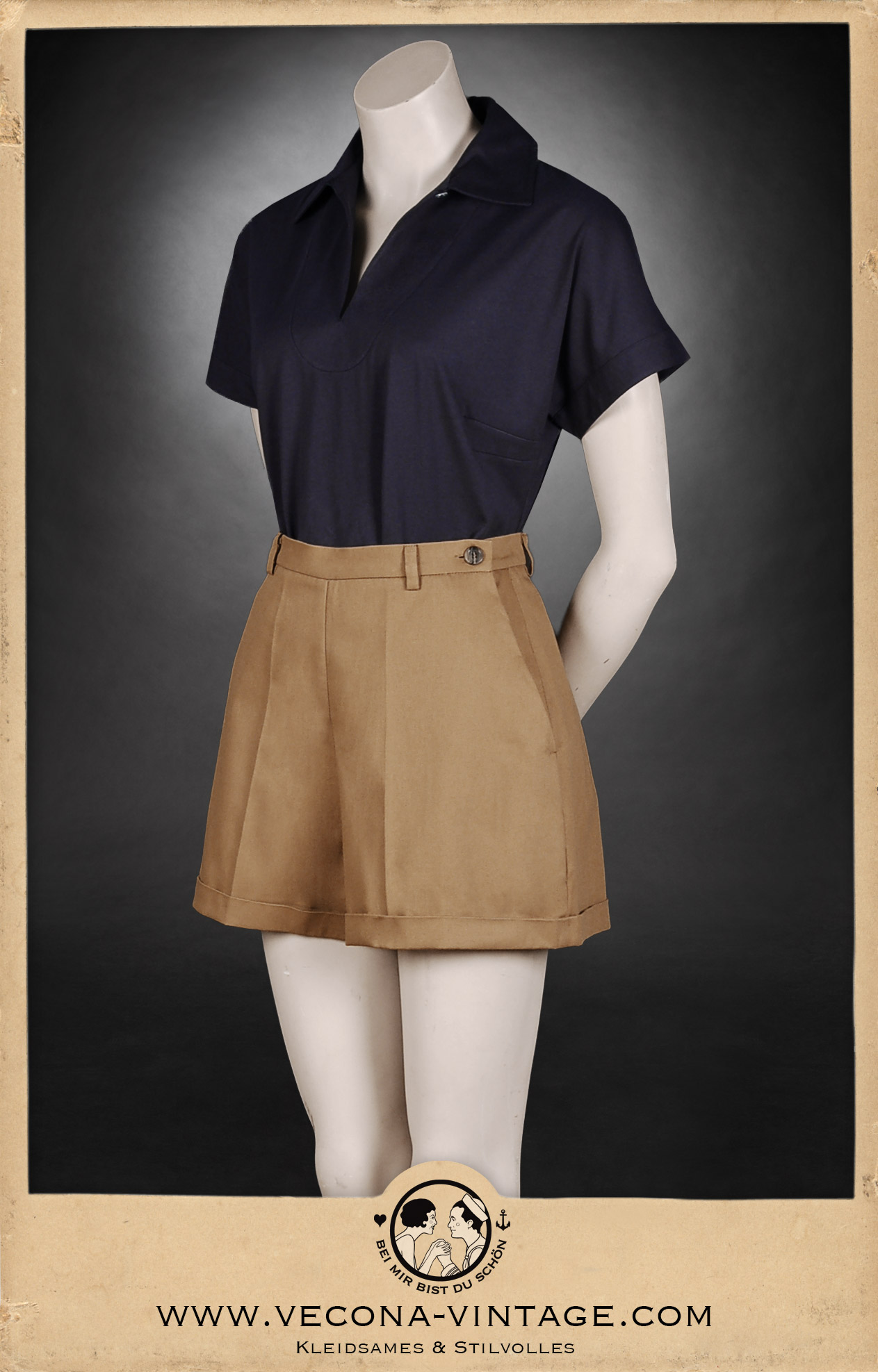 1930s vintage women's outfit consisting high waisted cotton gabardine shorts and a navy blue polo shirt, great for summer vacation and vintage sports. Front view.