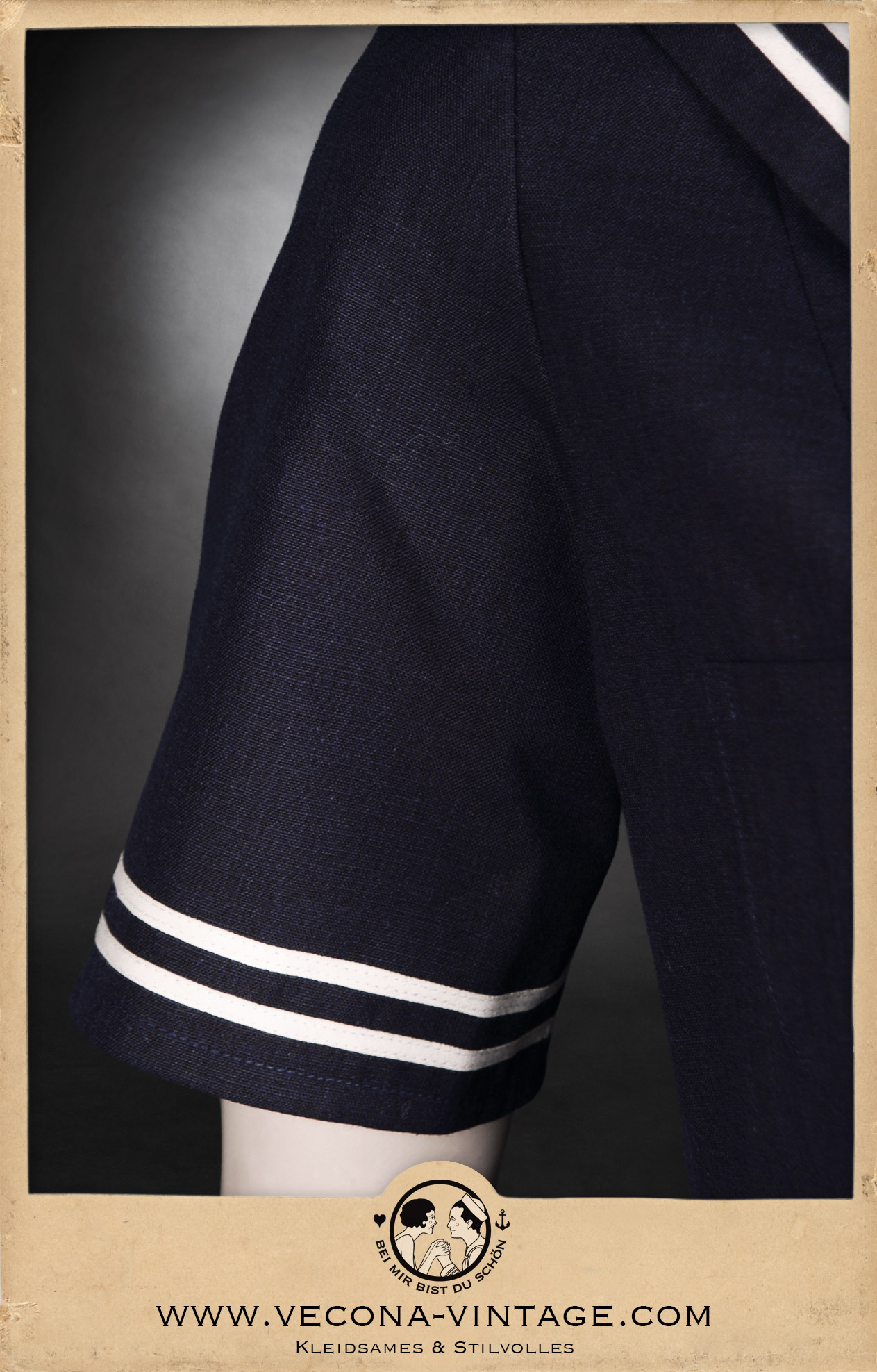 Sleeve detail of the 1930/40s style cotton linen sailor top High Tide in navy blue with off-white ribbon trimming for an authentic sailor look.