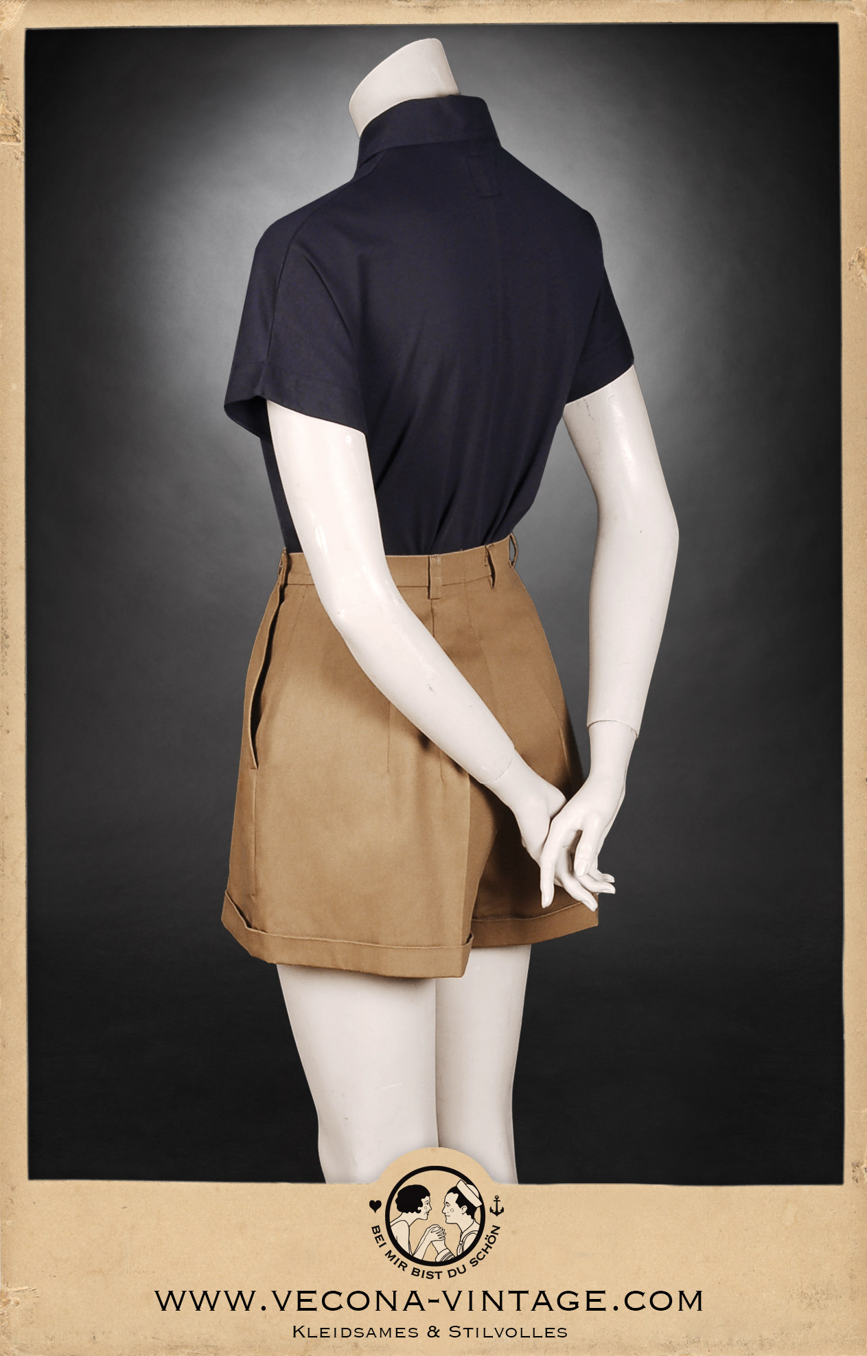 1930s vintage women's outfit consisting high waisted cotton gabardine shorts and a navy blue polo shirt, great for summer vacation and vintage sports. Back view.